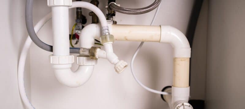 closeup of pipes under a sink